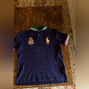 Men’s Ralph Lauren size medium, navy blue polo shirt, with insignias. Worn twice